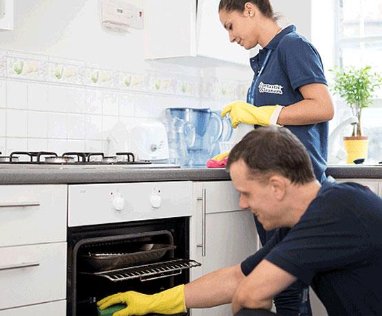 A team of 2 pros cleaning a kitchen