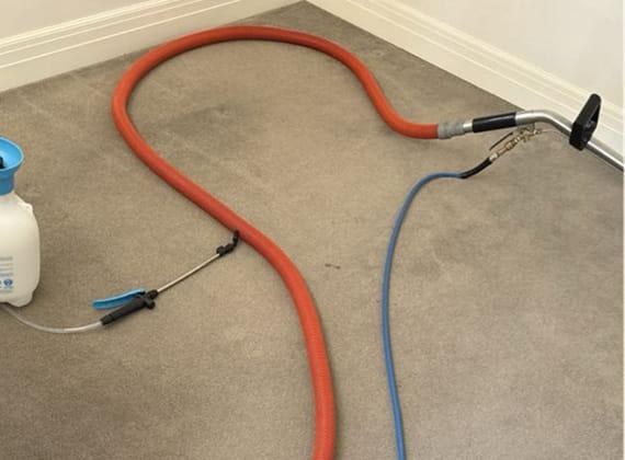 Hot water extraction hose and pre-spray line set up for carpet steam cleaning in a Melbourne home