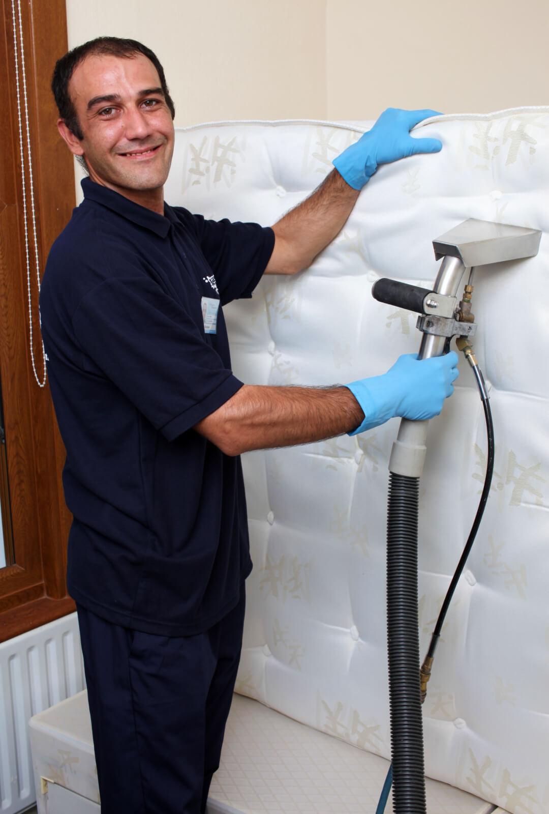 a professional cleaner cleaning a mattress